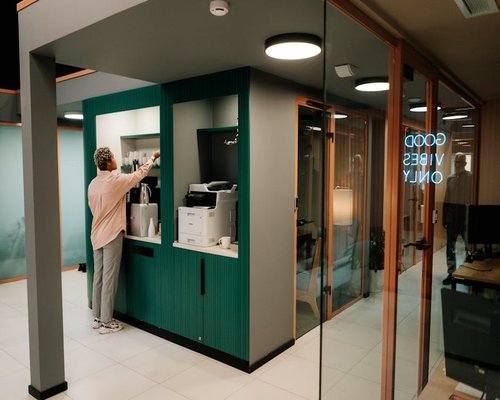 A person enjoying a coffee and taking a break in a modern urban coworking space