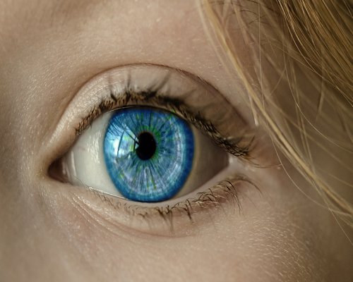 A close up of eyes looking at a soft glowing screen